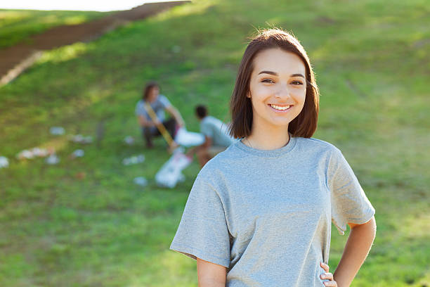 istock Young female volunteer helps pick up garbage in park 543457262