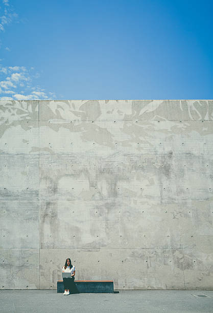 istock girl, laptop, concrete 543458984