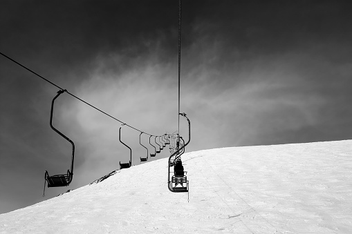 Black and white old chair-lift in ski resort. Caucasus Mountains, Elbrus region, mount Cheget.