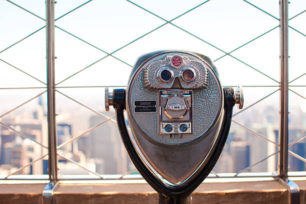 istock Public telescope pointed on Manhattan buildings 543460720
