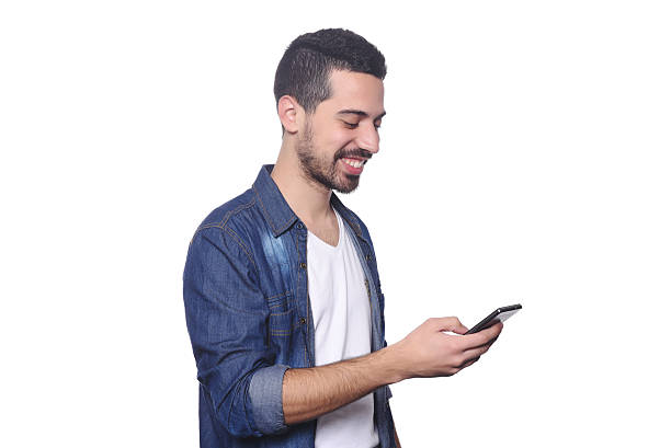 istock Young latin man typing on his smartphone. 543461470