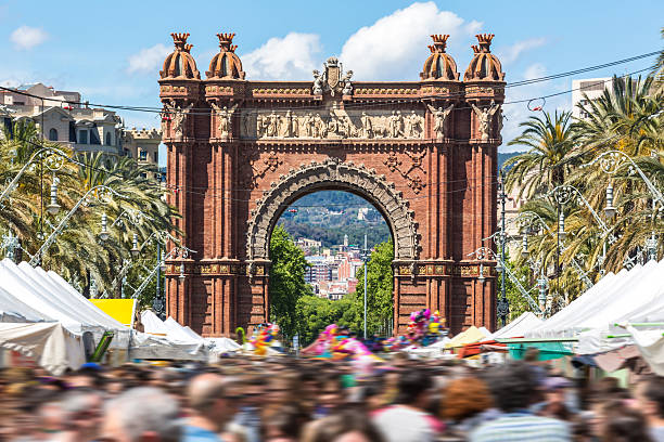 Arc de Triomph in Barcelona on a market day. Arc de Triomph in Barcelona. People are blurred. arc de triomf barcelona stock pictures, royalty-free photos & images