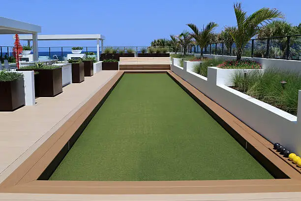 Beautiful bocce ball court with artificial turf, on a rooftop terrace, ready for play.