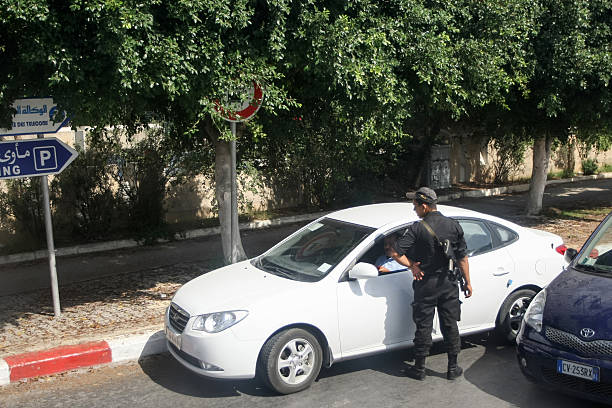Policeman checking driver in Tunis stock photo