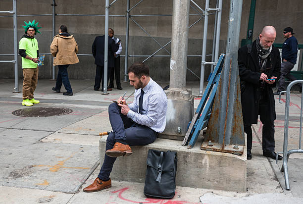 Full Length Portrait of a Confident Young Businessman Carrying a Briefcase Uses Smartphone While Walking on the City Street. Digital Marketing, Seo, E Commerce, Lifestyle, Social Media Network