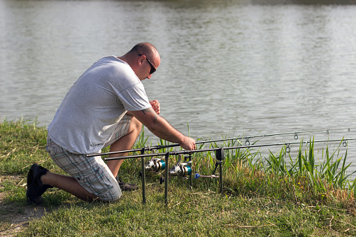 Man fishing at lake, Carp fishing