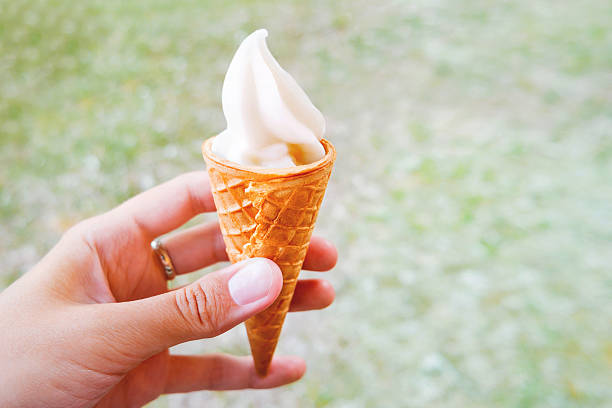 istock Woman holds an ice cream cone. Frozen dessert in waffle 543473188