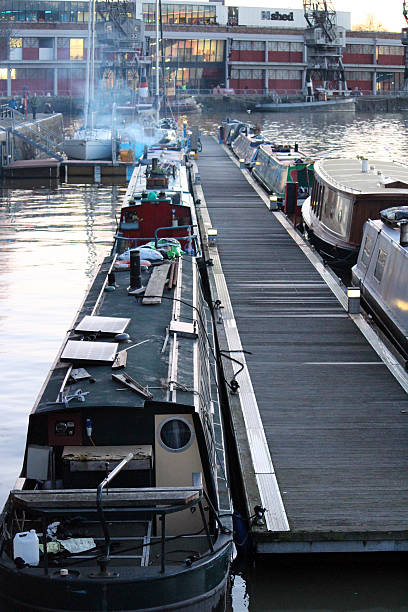 istock Canal Boats Sit Alonside Wooden Pier, Bristol Harbourside 543474270