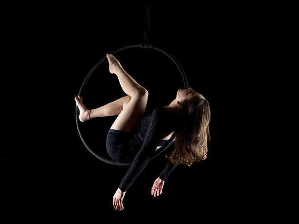 istock Graceful aerial dancer woman isolated on black 543474826