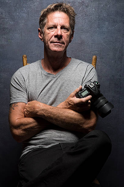 istock Mature Male Photographer Pose With DSLR Camera 543476920