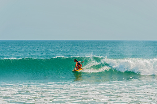 Plya Venao, Panama - March 23, 2016: Man surfing in the Pacific ocean in Playa Venao near Pedasi in Panama.
