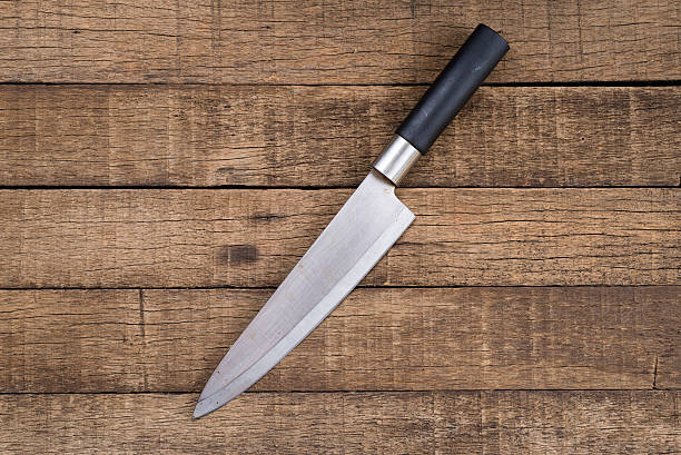 istock Food series : Knife on wooden plank background 543477706