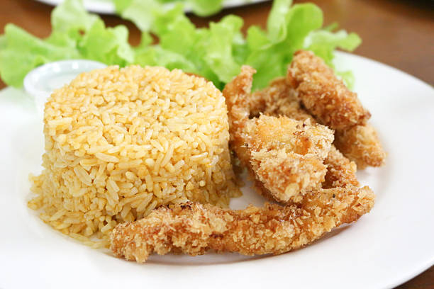 istock fried rice and breaded fried chicken in white plate 543478972