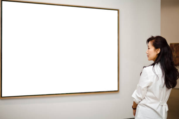 istock One woman looking at white frames in an art gallery 543479534