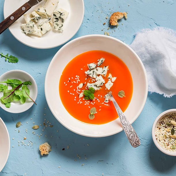 istock Pumpkin soup with blue cheese on a blue stone background. 543483088