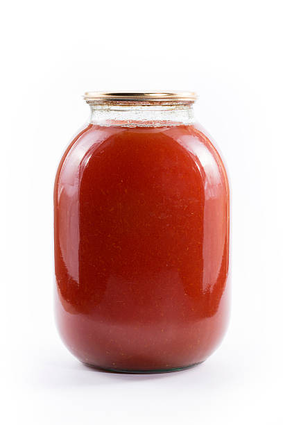 istock Three-liter jar of tomato juice on a white background 543484384