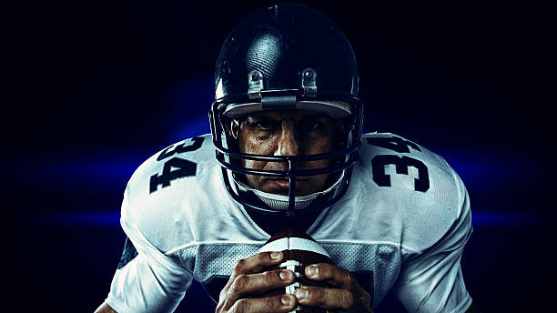 istock player gripping football 543485996