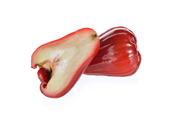 istock whole and half cut fresh rose apple fruit on white 543486726