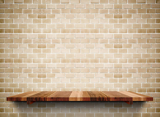 istock Empty wooden shelf on grunge brick wall 543487018