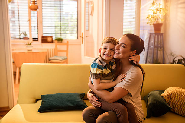 istock Affectionate mother and son embracing at home. 543487486