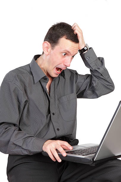 istock The surprised guy with the laptop isolated on a white 543487806