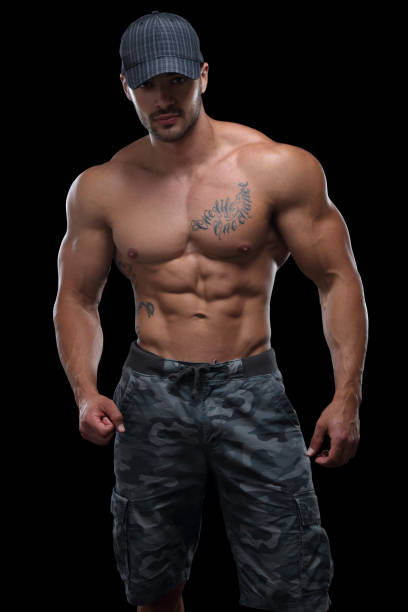 Handsome guy Muscular male posing in front of black background chest tattoos for men designs stock pictures, royalty-free photos & images