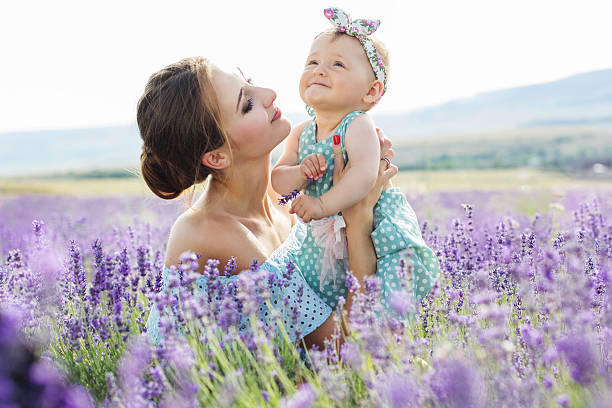 Mother with baby girl in lavender field stock photo