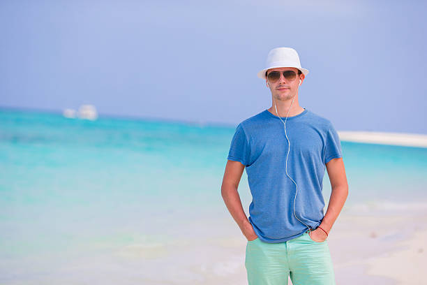 istock Young beautiful man relaxing at white sand tropical beach 543555930