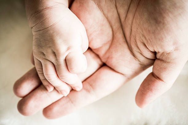 istock Asian father's hand and baby's hand 543556152