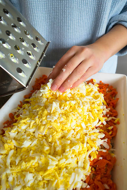 Grated carrots and boiled eggs prepared for making nutritious salad