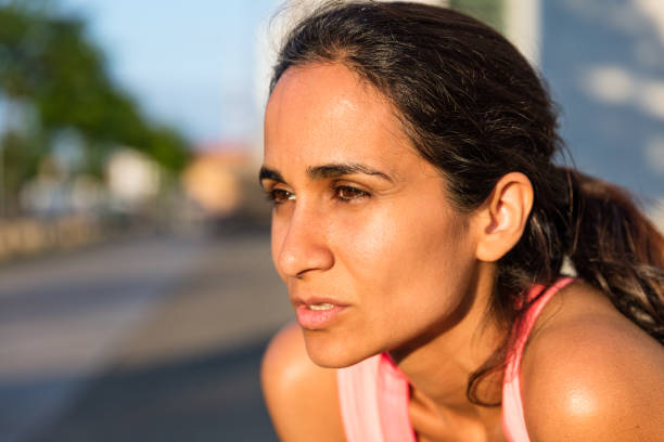 istock sporty young woman relaxing after run 543561748