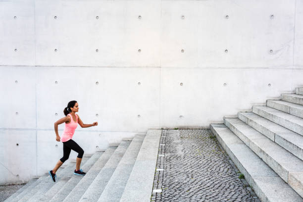 istock Woman running up steps in urban setting 543562104