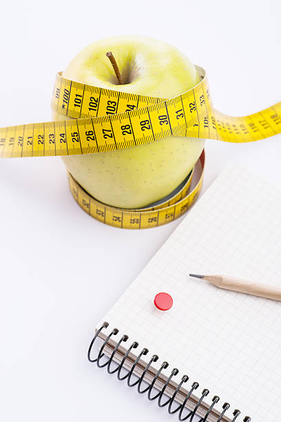 istock Fresh and green organic apple with metering tape 543563054