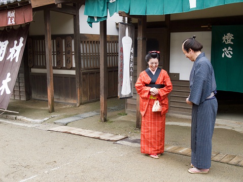 Japanese merchant and young woman in kimono in Edo period