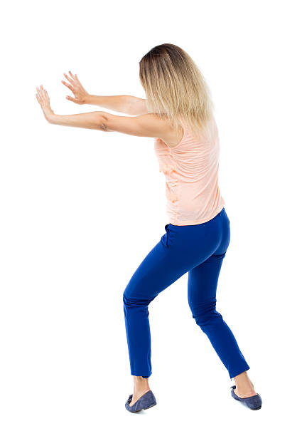 istock back view of woman pushes wall. 543563478