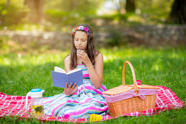 istock Girl learning on summer vacation and reading book 543564038