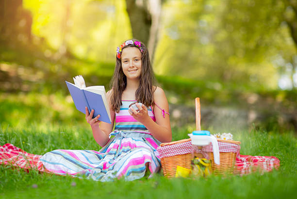 istock Girl learning on summer vacation and reading book 543564498