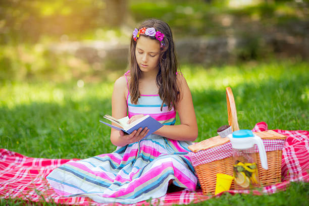 istock Girl learning on summer vacation and reading book 543564748