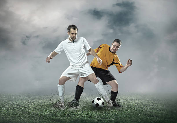 istock Football player with ball in action under sky with clouds 543566558