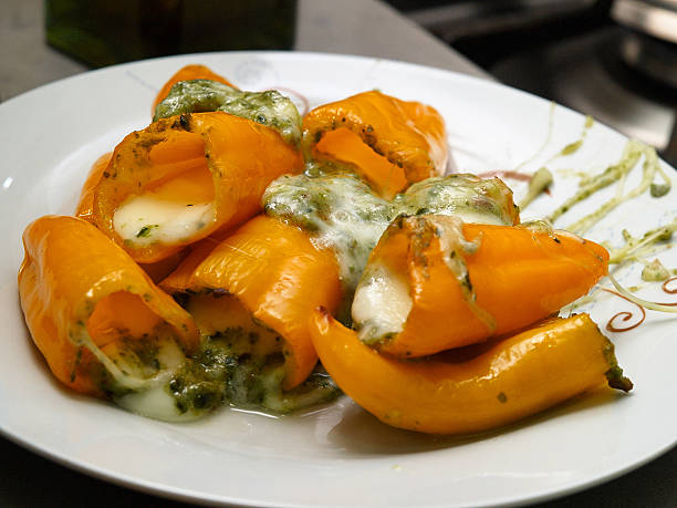 Baked stuffed yellow peppers stock photo