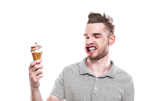 Funny concept for man with windblown mouth. Man holding ice cream. Isolated on white background