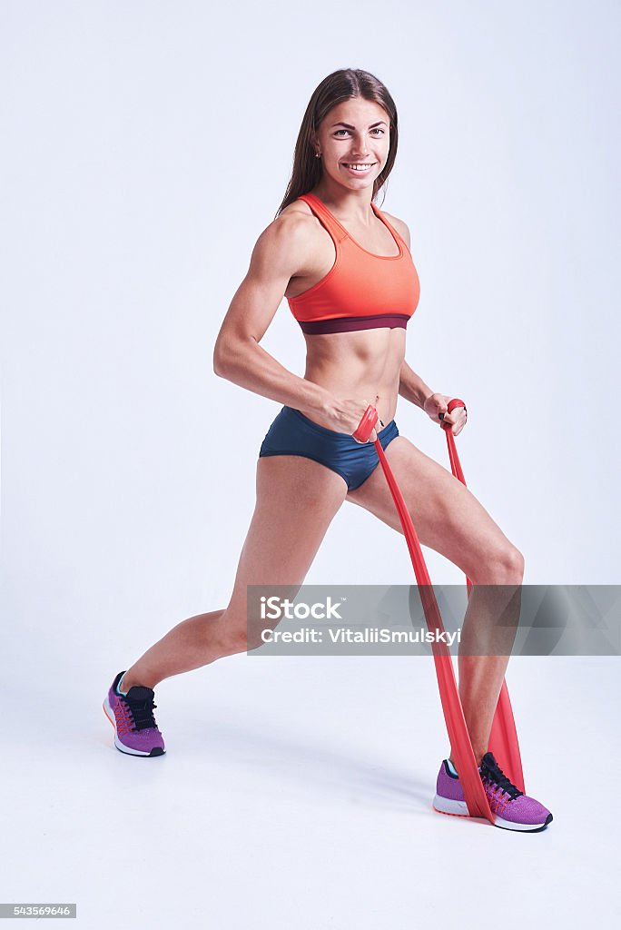 Woman doing exercises with resistance band. Fitness, workout, sport, training, Woman doing exercises with resistance band. Fitness, workout, sport, training, people and lifestyle concept. Isolated on white background Active Lifestyle Stock Photo