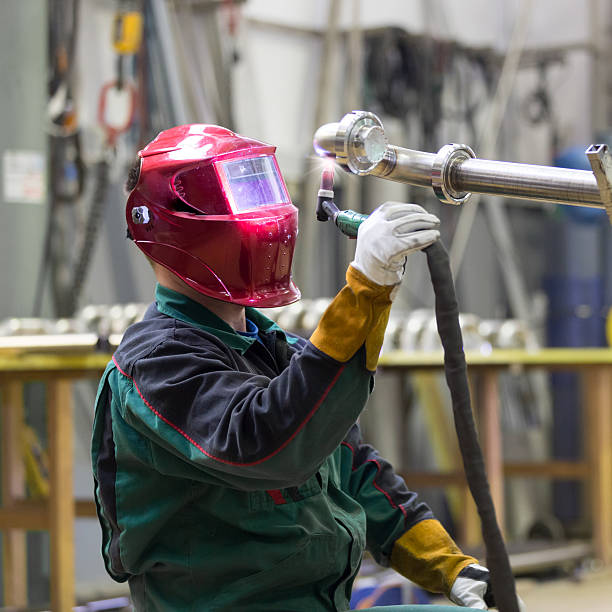istock Industrial worker welding in metal factory. 543570256