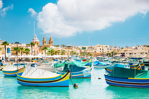 Marsaxlokk Harbor. Marsaxlokk in Malta is a fishing village in the Southpart famous for its fish market, colourful boats and fish restaurants.
