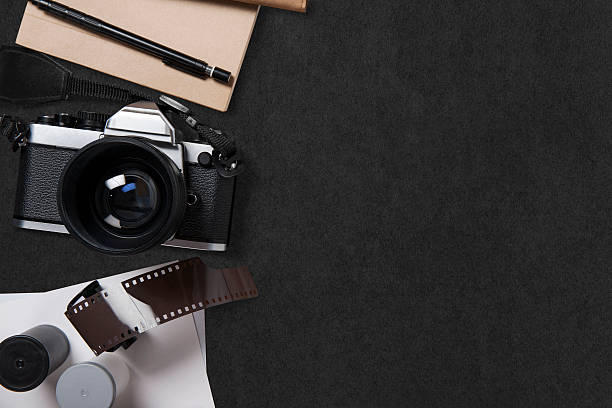 istock camera and supplies, Blank photo on black table 543570738
