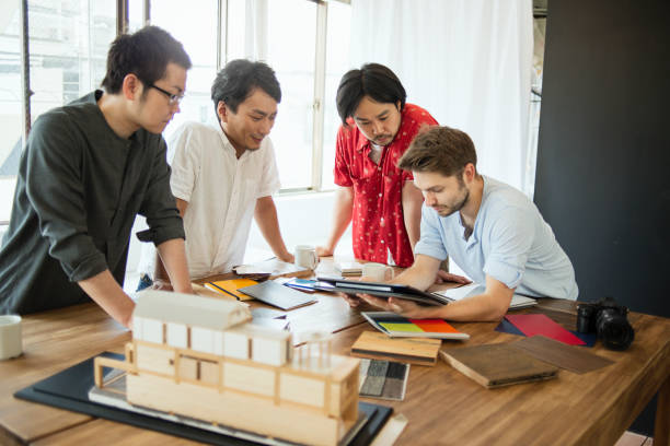 istock Team of Interior designers looking at a digital tablet 543572230