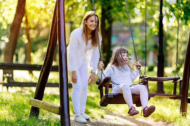 istock Handicapped child enjoying the swing 543574888