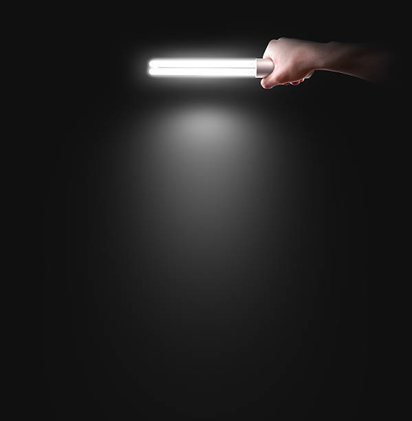 Hand holding lamp near the wall, isolated. Idea, logo, poster
