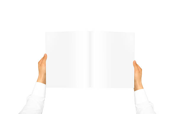 istock Hand in white shirt sleeve holding blank journal 543576064