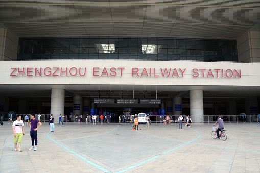 Zhengzhou, China - June 21, 2016: The large Zhengzhou East Railway Station, building entrance. Travelers getting to the building.